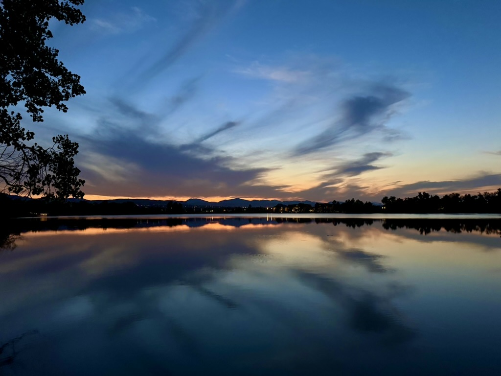 Colorado lake reflecting a blue and orange sunset