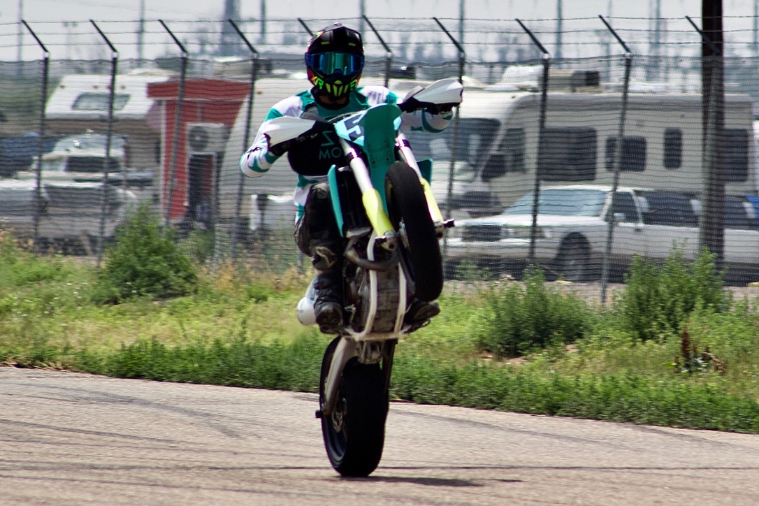 Motorcycle rider performing a wheelie